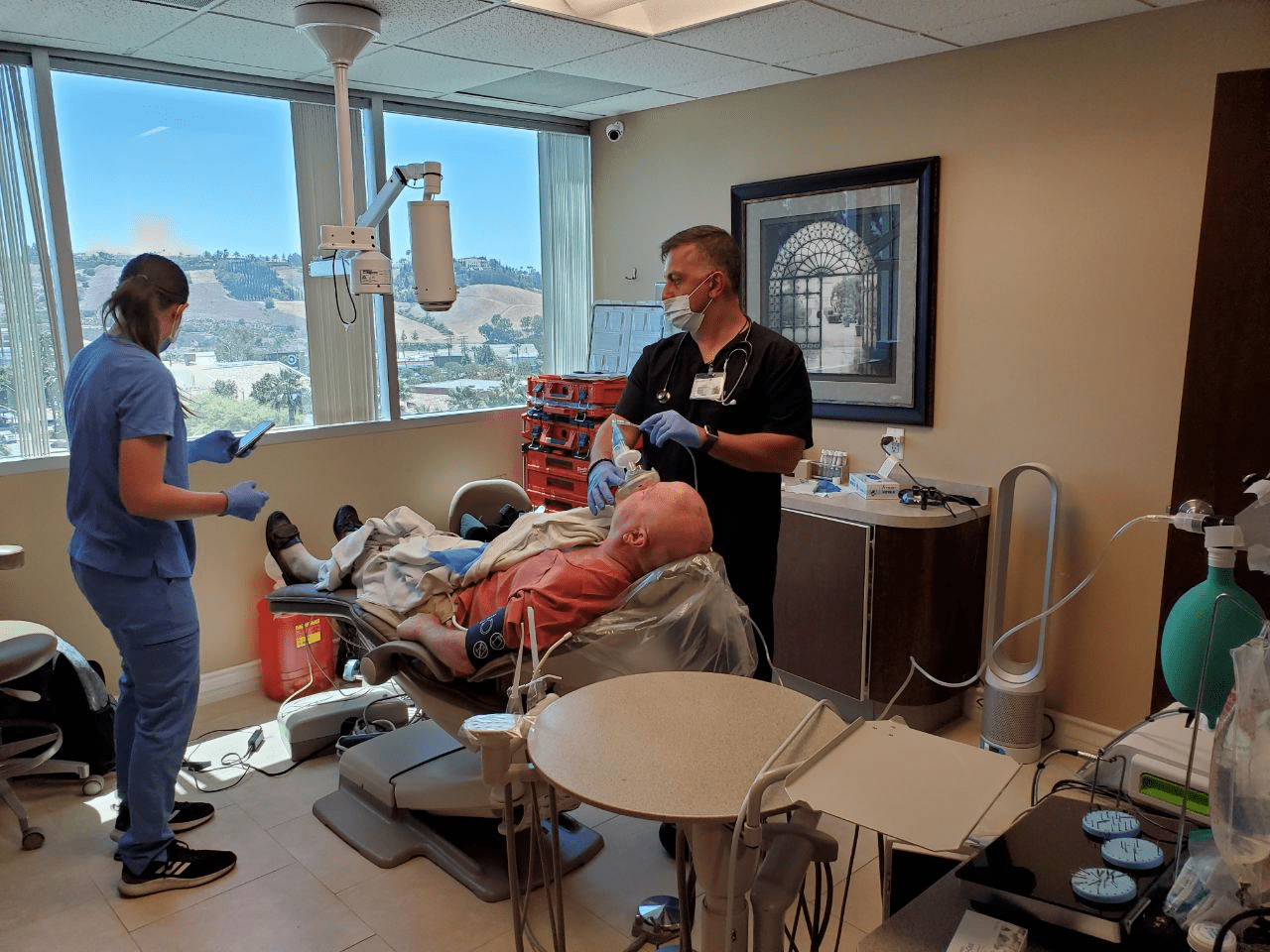 A team of dentists helping a patient